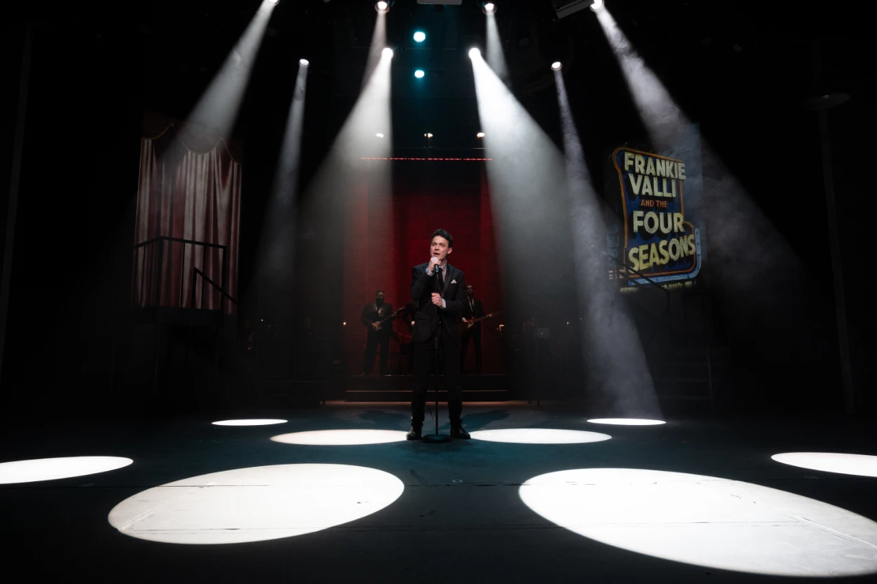 Jersey Boys performance with a projected Frankie Valli and the Four Seasons sign